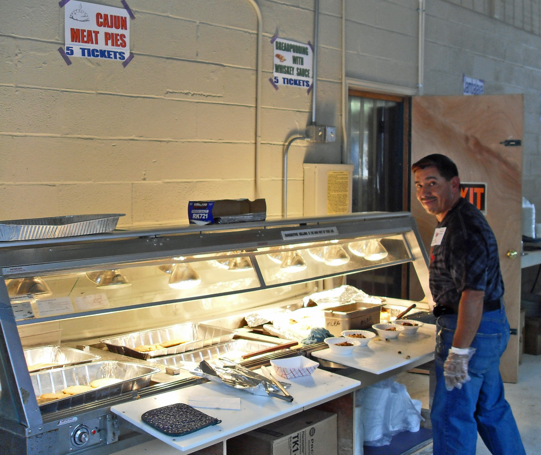 Festival volunteer serving Cajun food
