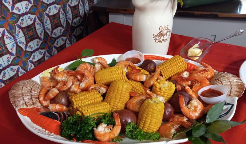 Cajun seafood platter with shrimp, corn and potatoes