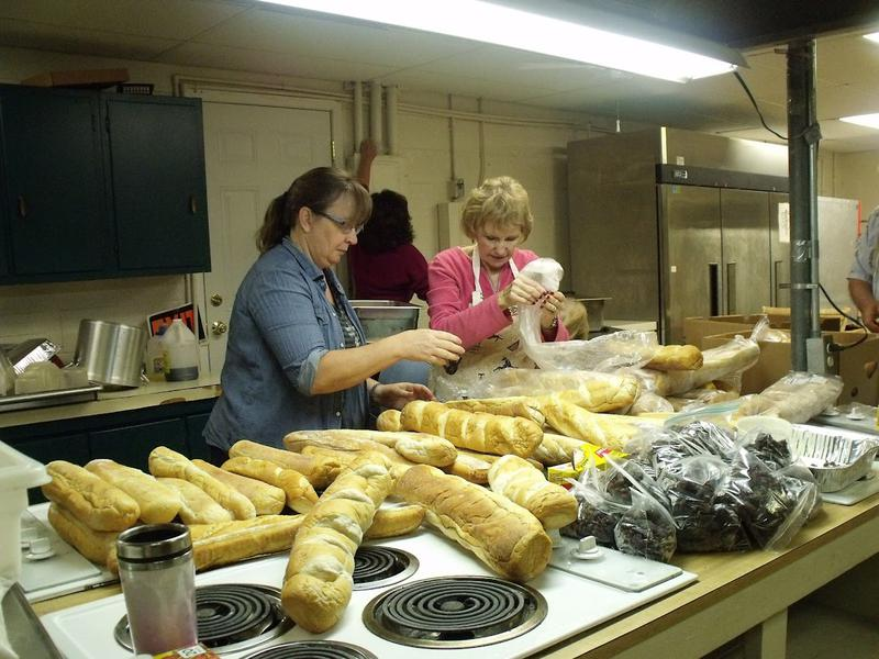 Volunteers preparing bread for Cajun festival food service